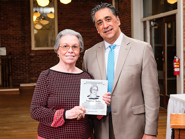 Bamin Khomami presents Virginia Butler with her plaque.