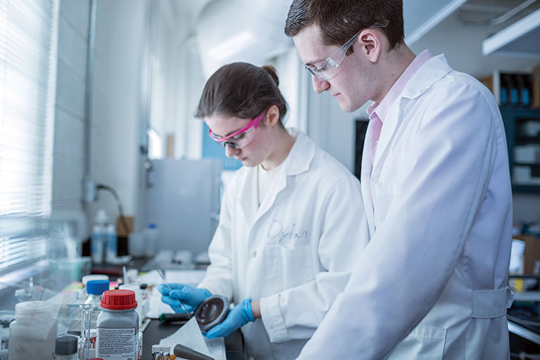 Two students work in a chemical and biomolecular engineering lab.