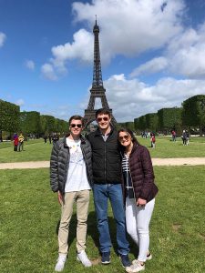Jim Baker and two friends in front of the Eiffel Tower.