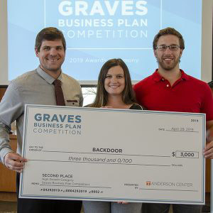 Brad Bennett and rest of Backdoor team receive second place check in the Graves Business Plan Competition.