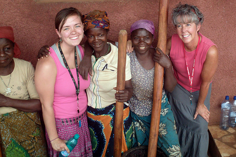 Angie poses with several women, including her daughter, in Mozambique.