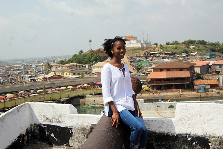 Naydia Futrell-Peoples poses at the top of a building.