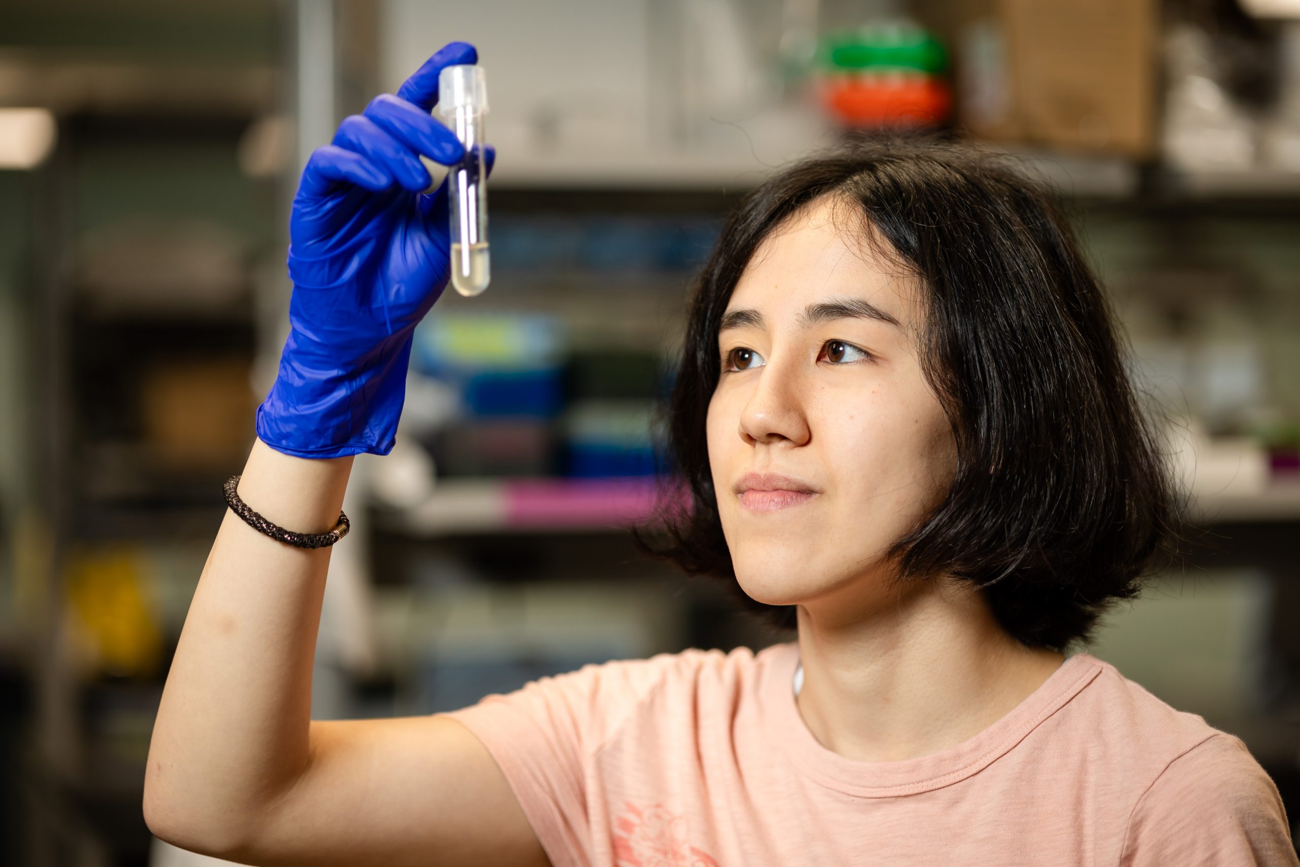 Hannah Boyd looking in a beaker in the lab