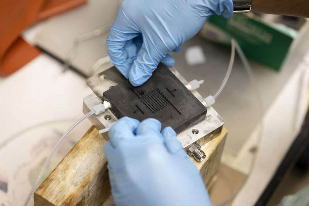 student working on a lithium battery in a lab