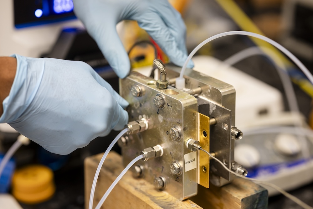 hands setting up a lithium battery in a lab