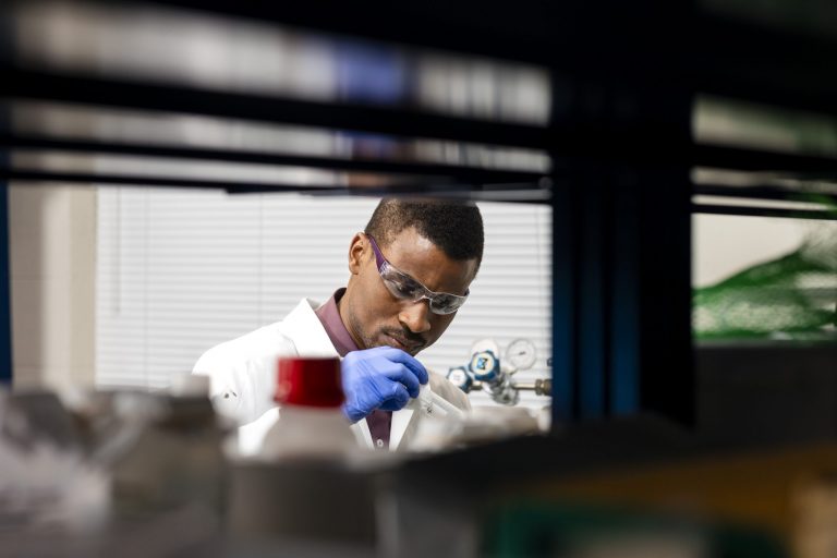 Christian Kemefa working in the lab