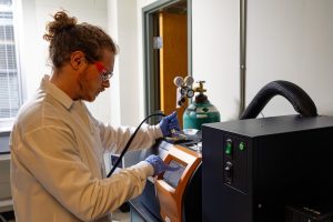 Zack Sparks working on a machine in a lab